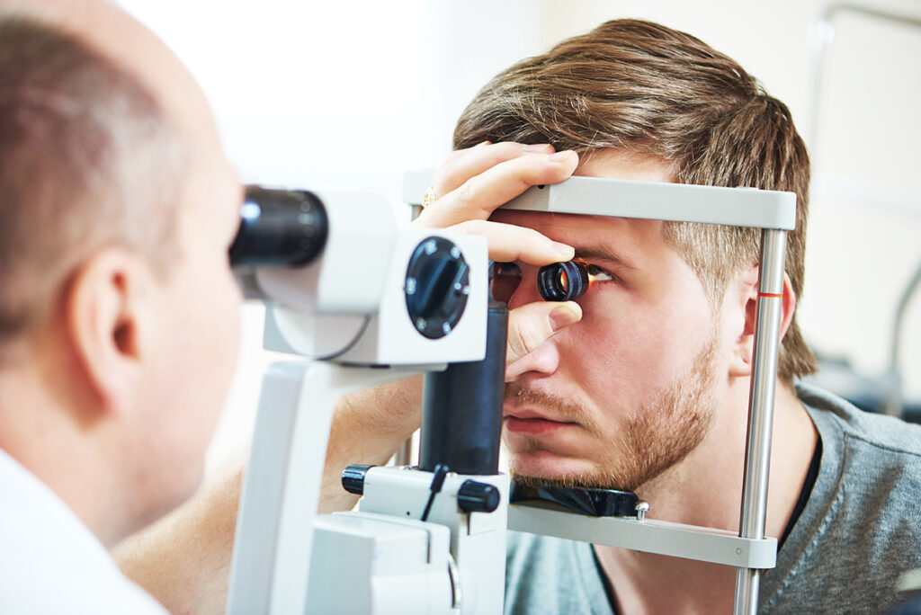 Ophthalmology concept. Male patient under eye vision examination in eyesight ophthalmological correction clinic.